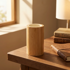 Bamboo Pen Stand PS-2 on a warm walnut desk corner with a small lamp and books