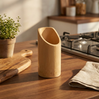 Bamboo Pen Stand PS-3 on a kitchen counter near a stovetop, with cutting board and plant