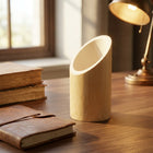 Bamboo Pen Stand PS-1 on a warm walnut desk with leather journal, books, and brass lamp