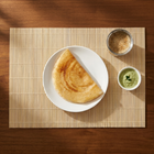 Classic bamboo placemat overhead with dosa and filter coffee