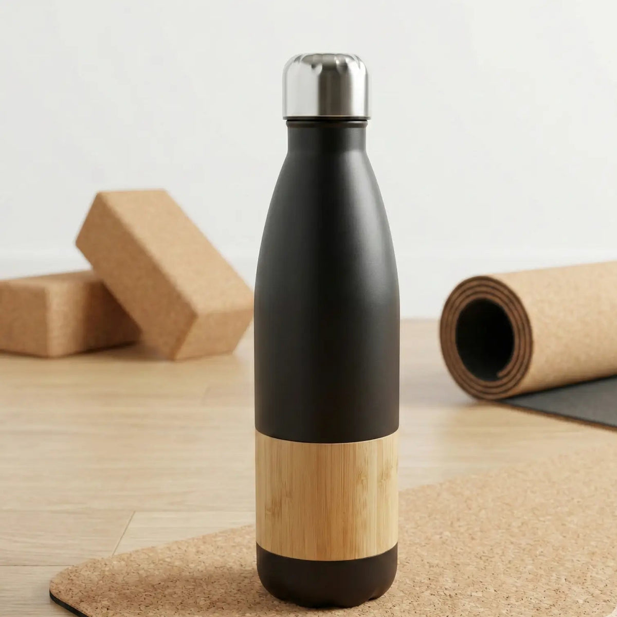 Bamboo Vacuum Flask - 500ml featuring a stylish black and bamboo design on a cork surface.