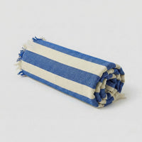 Bamboo Bath Towel rolled and folded with blue and white stripes, showcasing its stylish design.