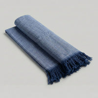 Bamboo Bath Towel in blue folded with fringed edges, perfect for everyday use and stylish bathroom decor.