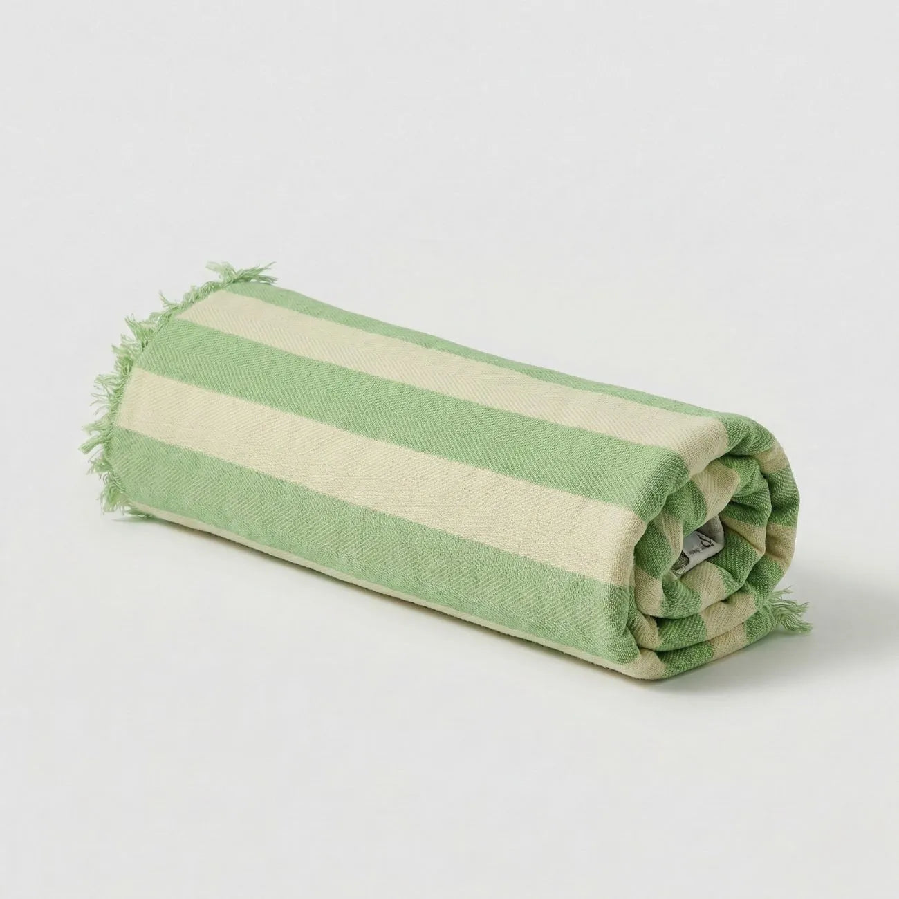Rolled Bamboo Bath Towel with green and beige stripes, ideal for stylish bath routines.