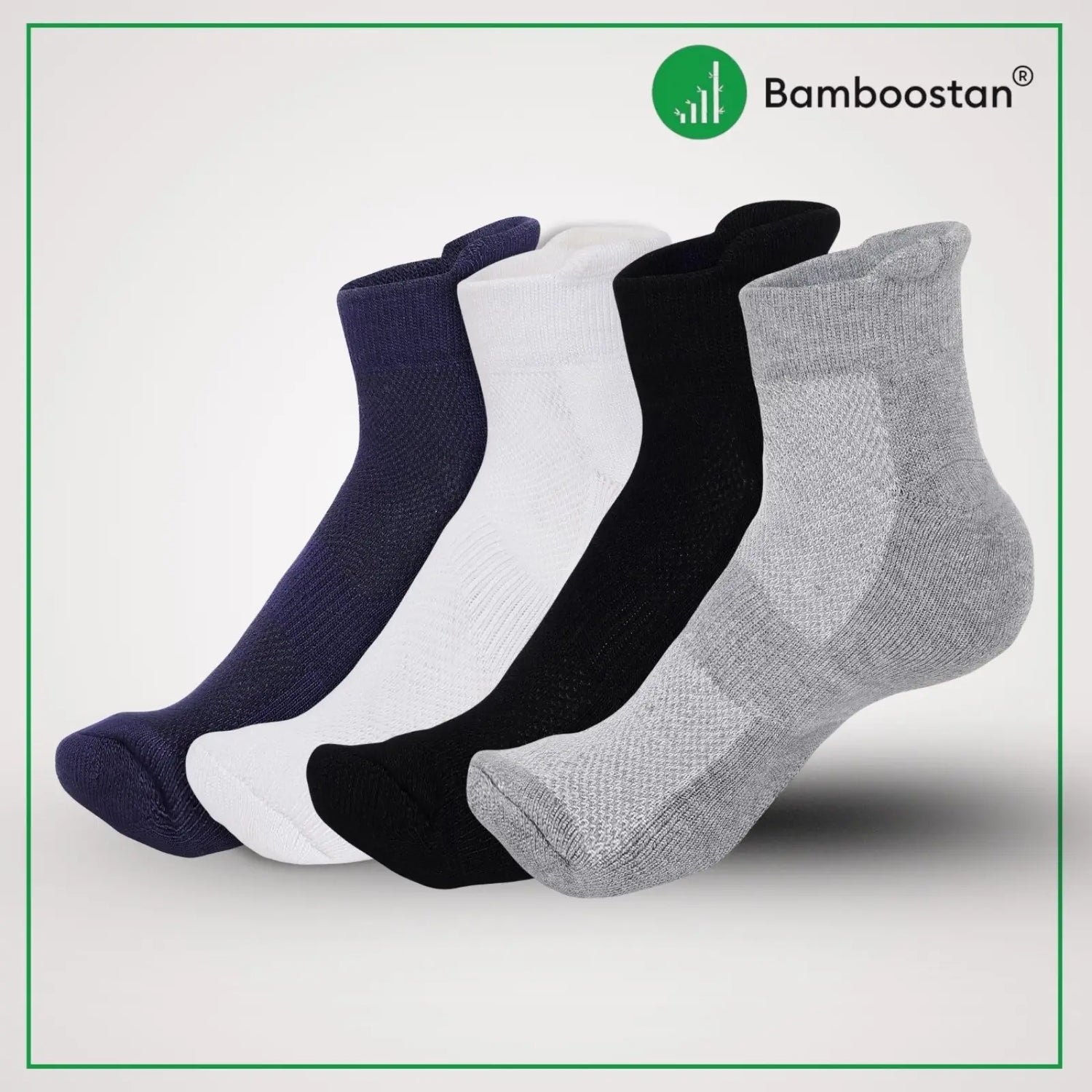 Four pairs of bamboo socks in navy, white, black, and gray on a light gray background with Bamboostan logo.
