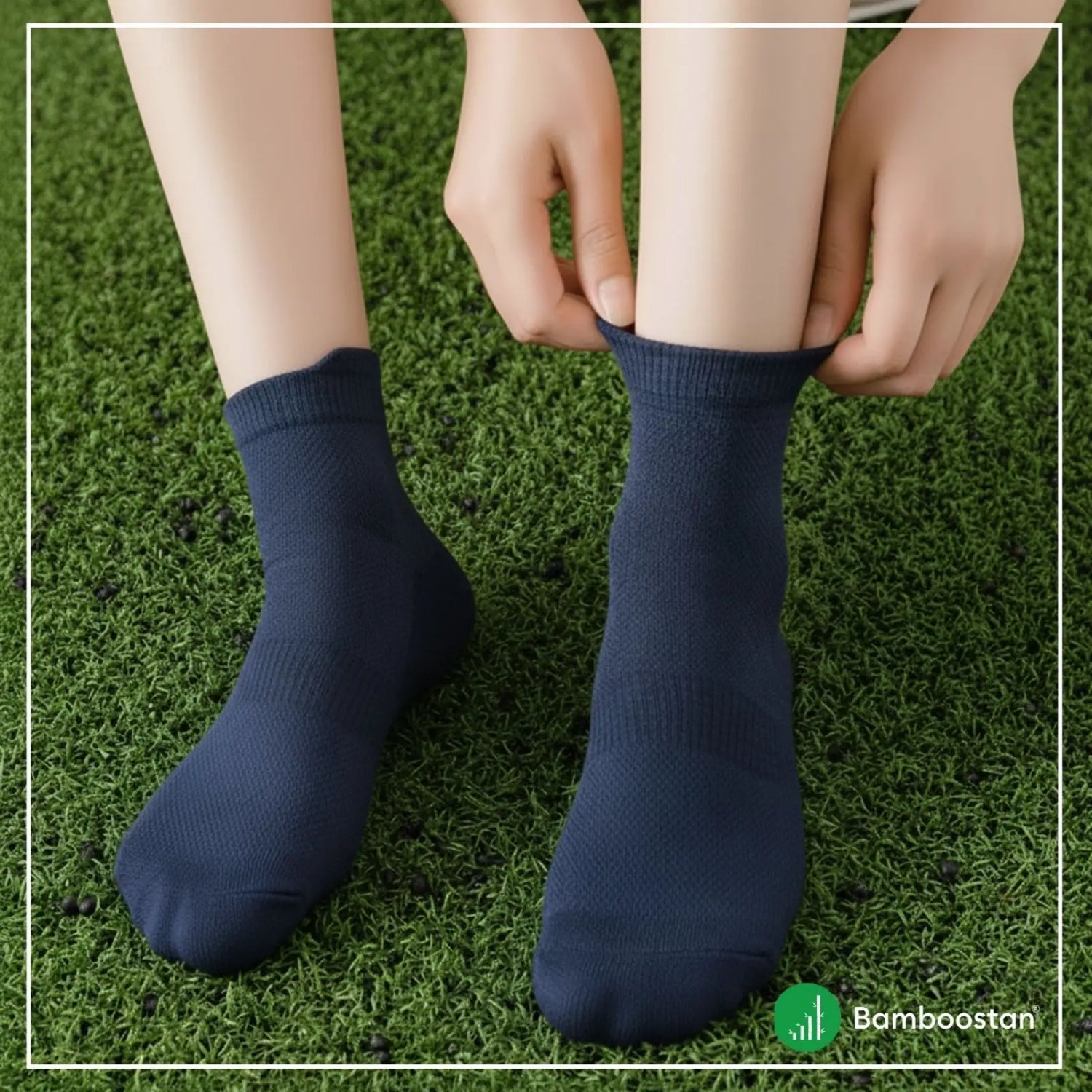 Person wearing navy blue bamboo socks on a grassy background with 'Bamboostan' branding.