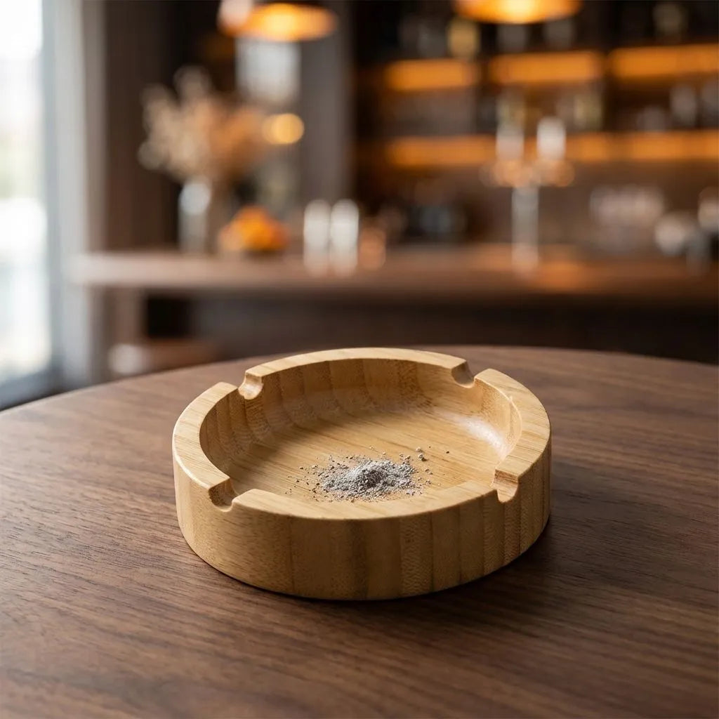 Bamboo round ashtray on a wooden table with a blurred background