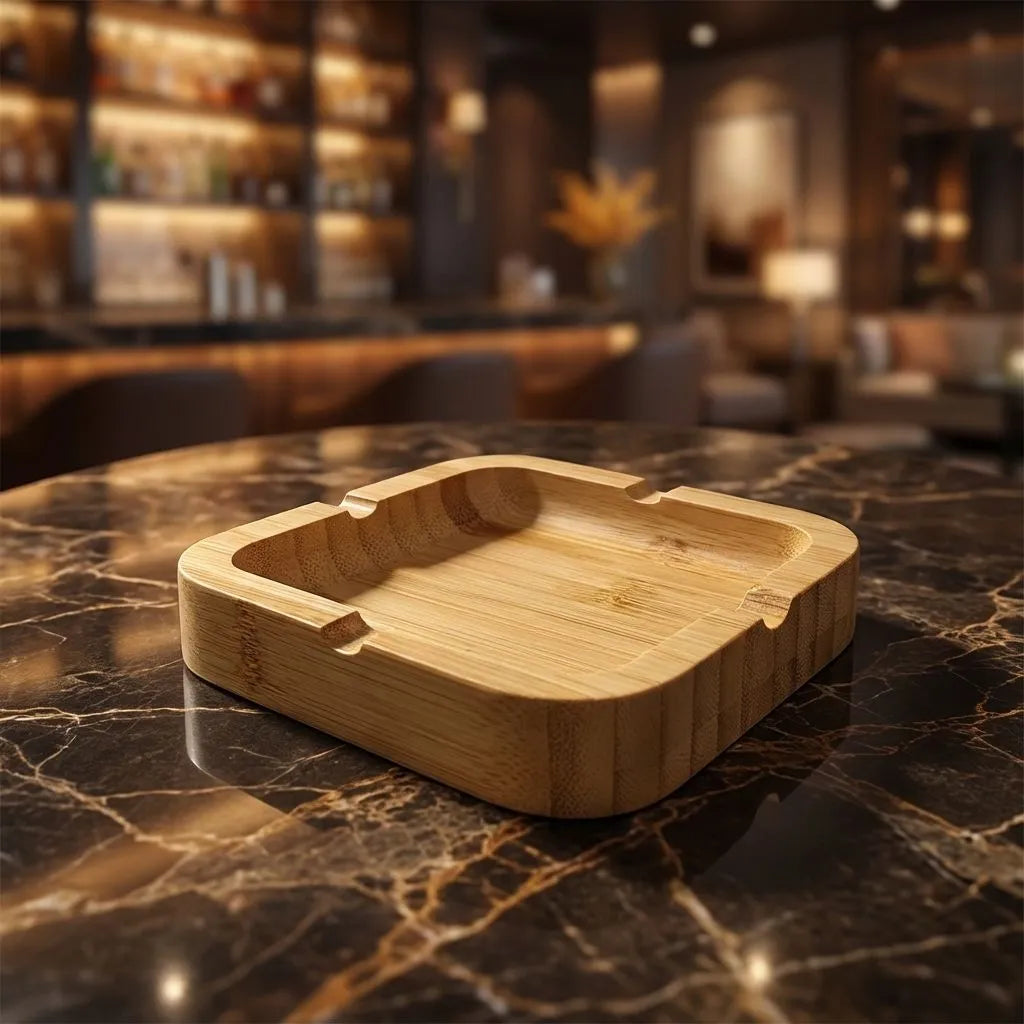 Bamboo square ashtray on a marble countertop with a blurred bar background