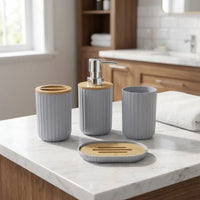 Stylish 4-piece bathroom accessory set on marble countertop, featuring soap dispenser, toothbrush holder, tumbler, and soap dish.