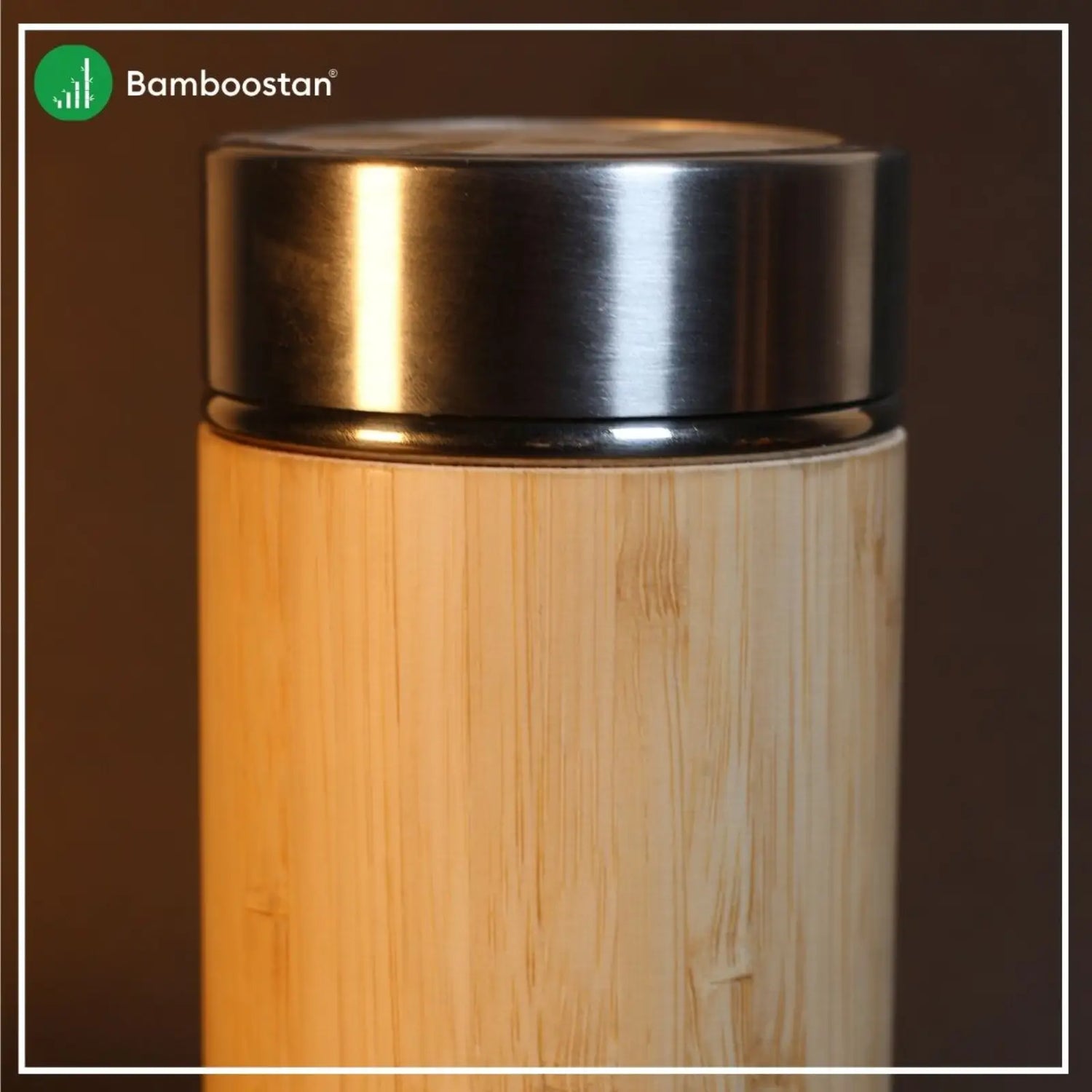 Bamboo bottle with metallic lid on a dark background