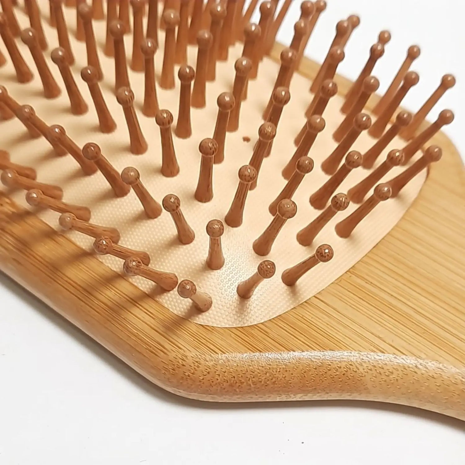 Bamboo hairbrush with bristles on a white background