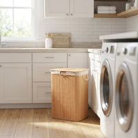 Bamboo Laundry Basket placed in a modern laundry room beside a washer and dryer, featuring a natural bamboo design.