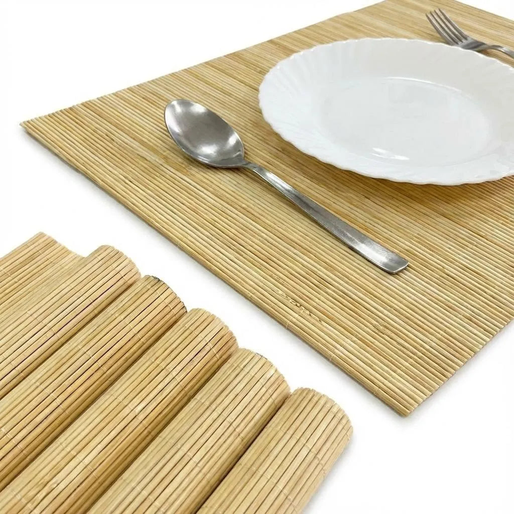 Set of bamboo placemats with a plate, spoon, and fork on a white background