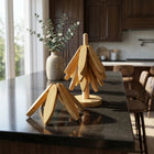 Bamboo Trivet Set displayed on a kitchen countertop with natural light, featuring a unique tree-shaped design.