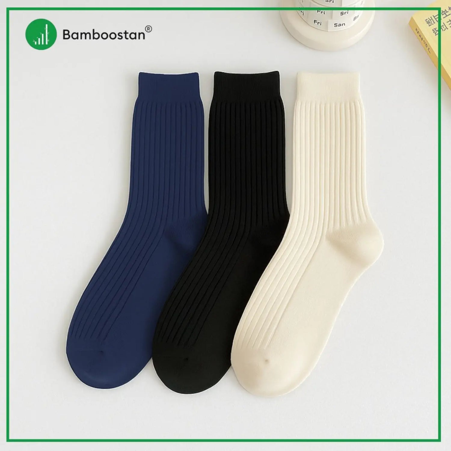 Three bamboo socks in blue, black, and beige on a light gray background with 'Bamboostan' branding.