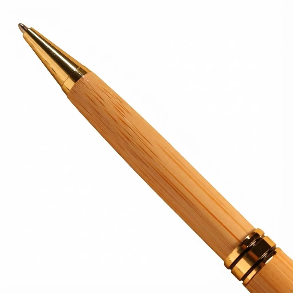 Bamboo pen with gold accents on a white background