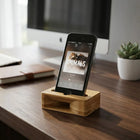 Bamboo Amplifier holding a smartphone on a desk with a modern design, enhancing sound naturally.