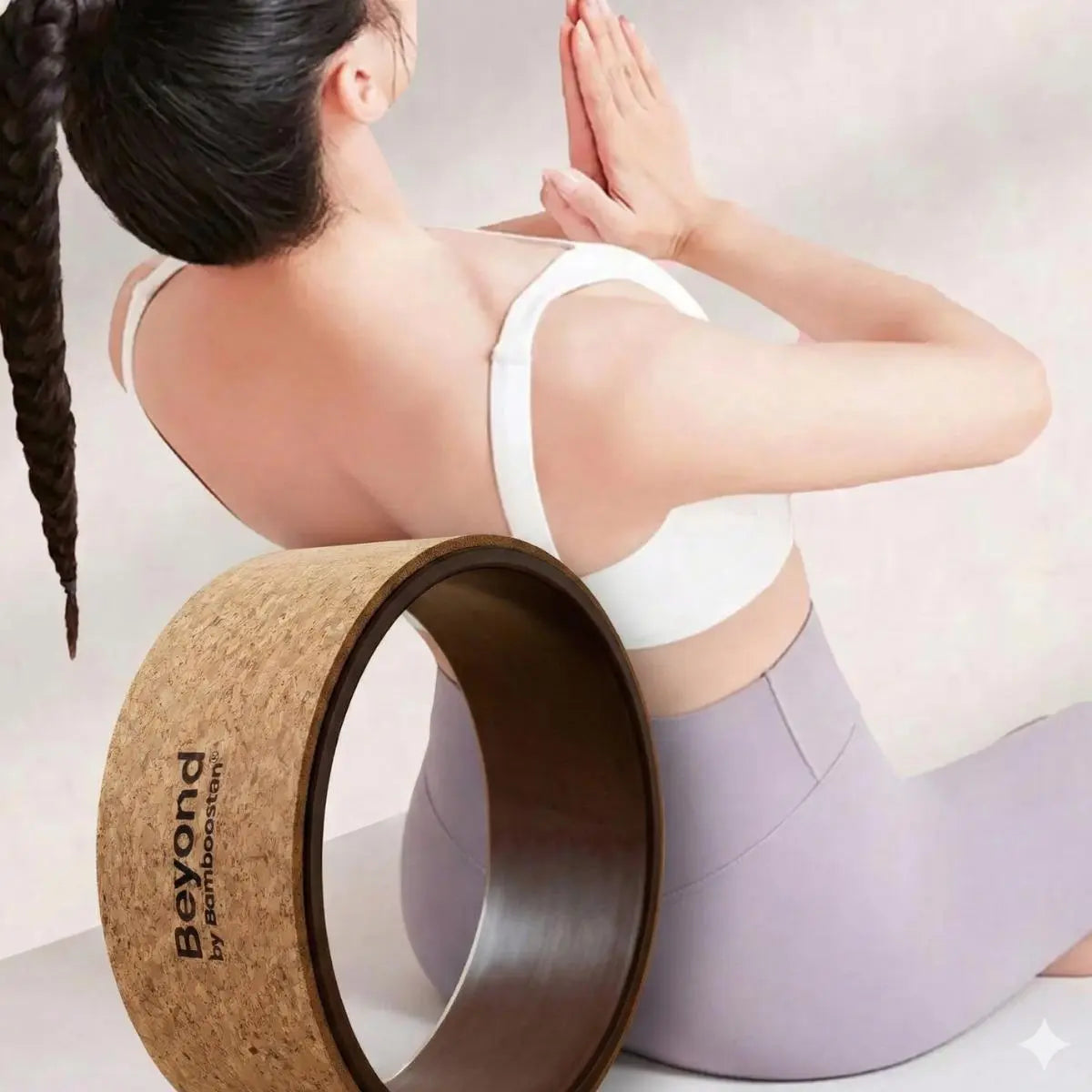 Yoga Wheel made of cork used by a woman practicing yoga in a comfortable pose.