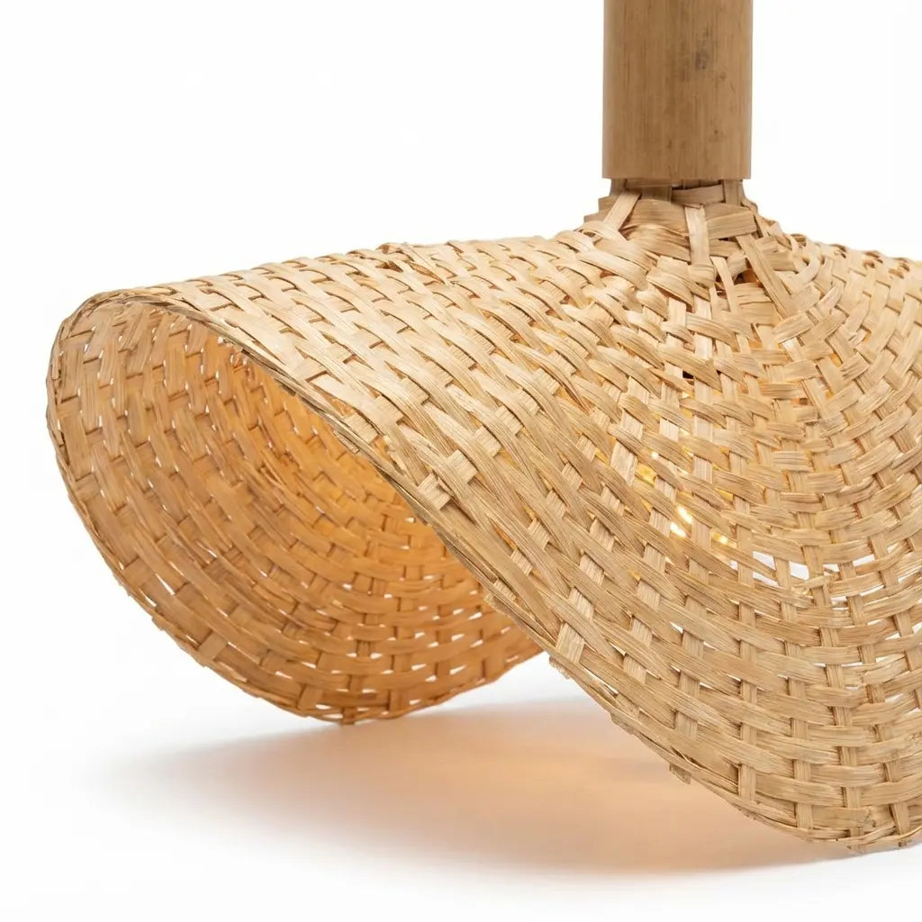 Close-up of a woven bamboo lamp with a wooden handle on a white background