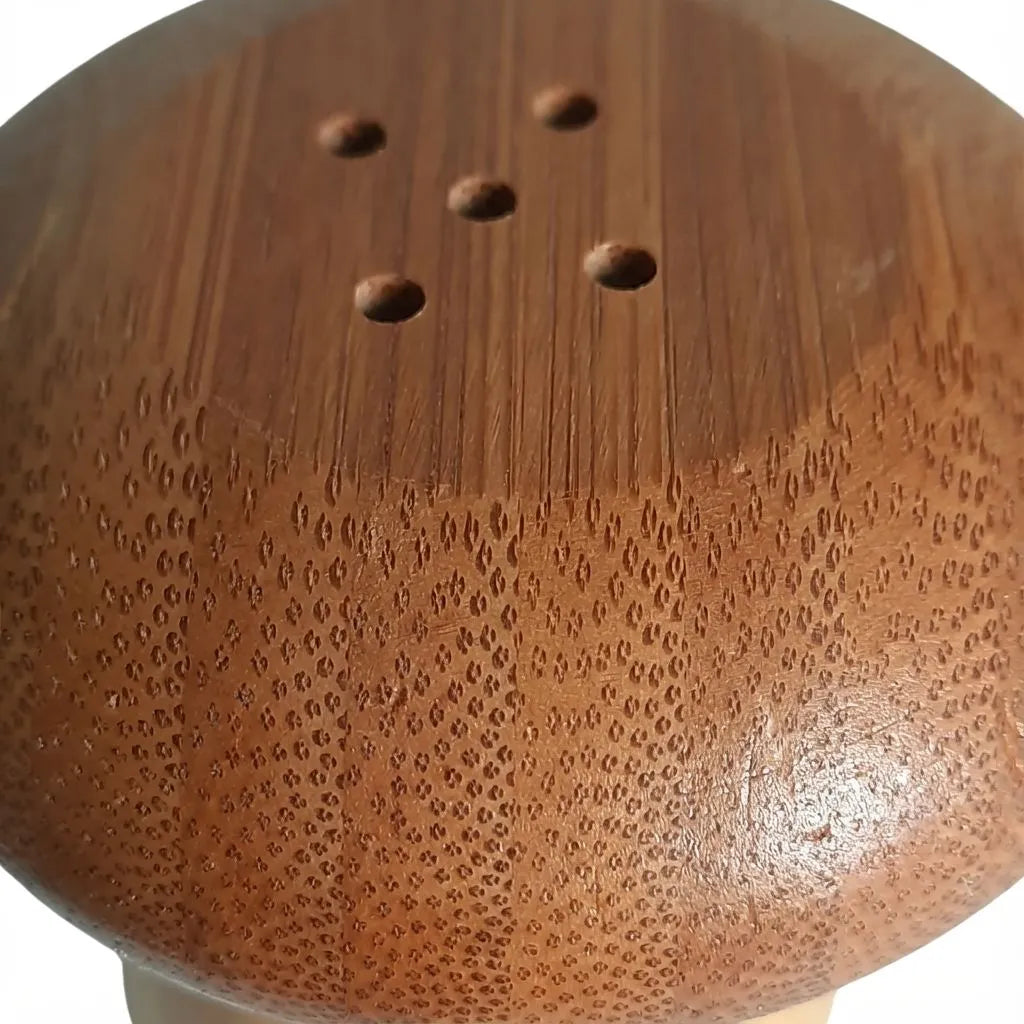 Close-up of a mushroom shape bamboo toothpick holder with a textured surface.