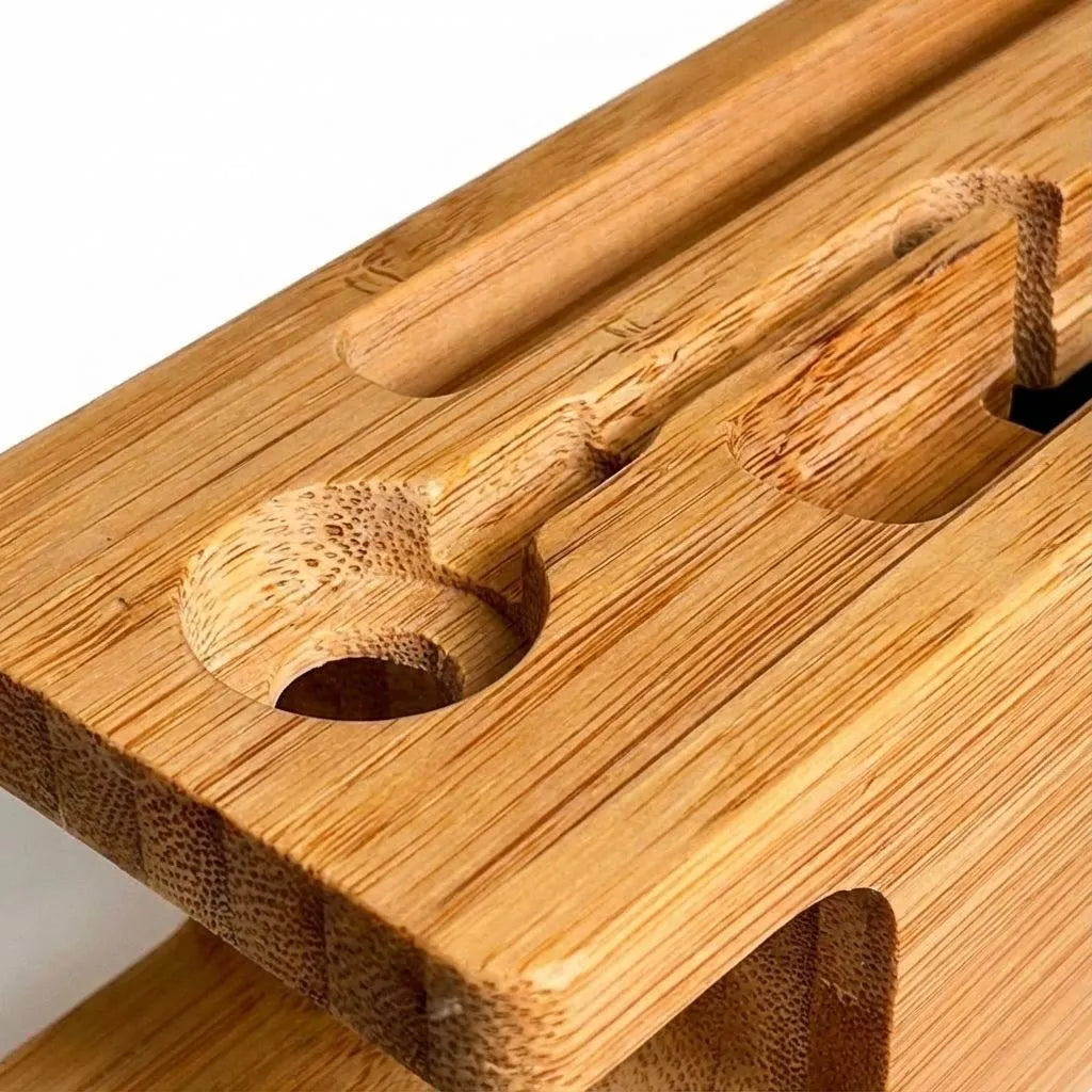 Close-up of a bamboo phone stand with multiple slots.