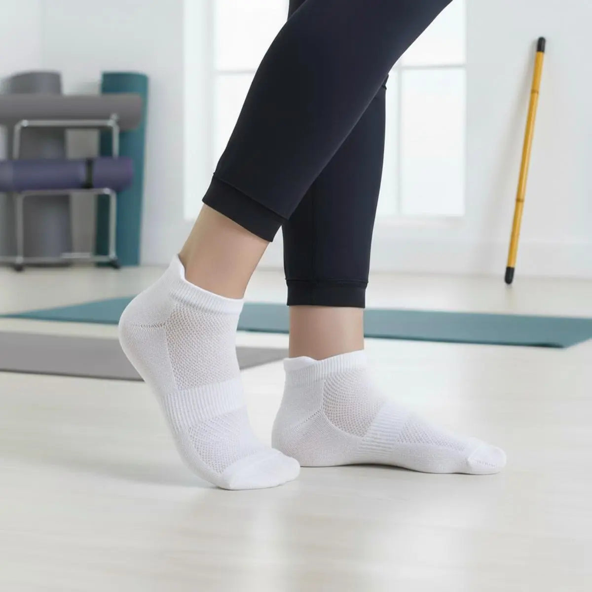 Person wearing Bamboo Ankle Socks while exercising on a yoga mat in a bright home setting.