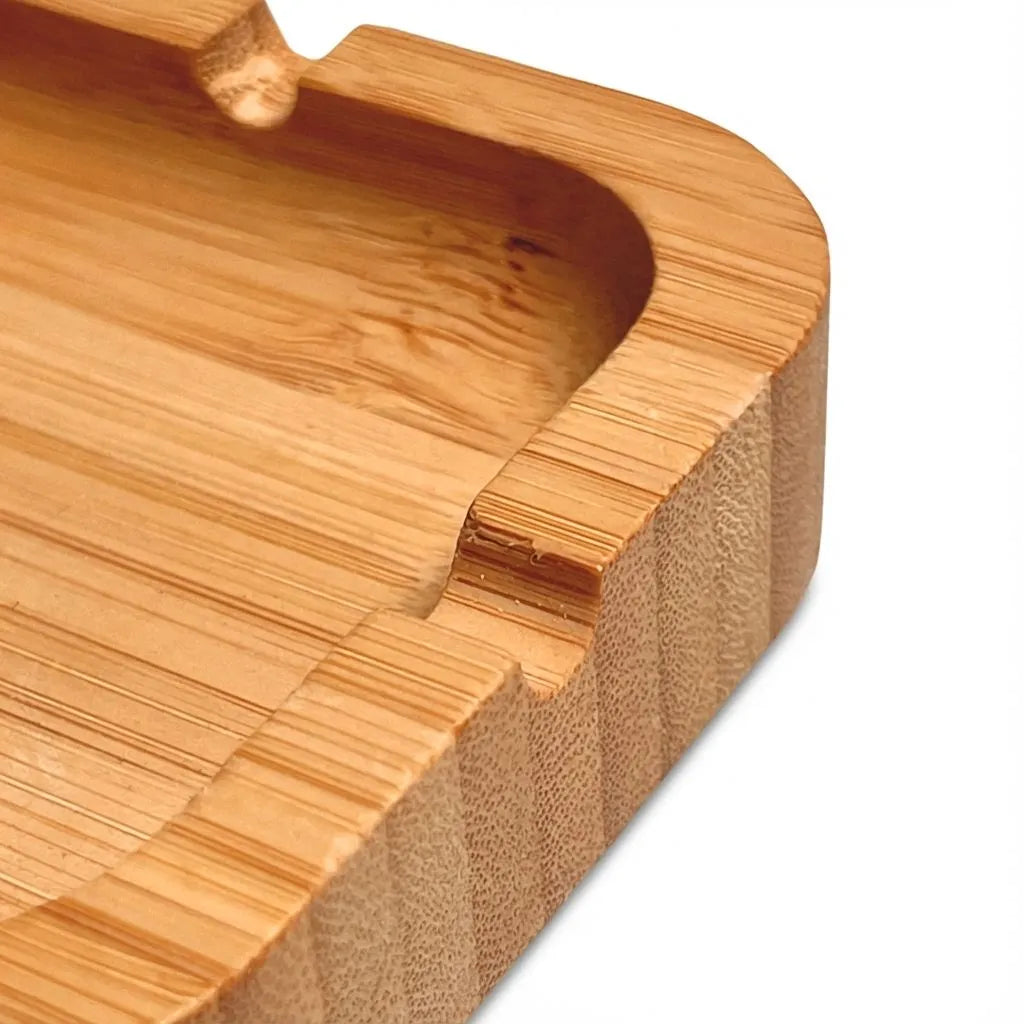 Close-up of a bamboo ashtray with a curved edge on a white background