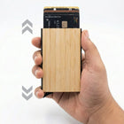 Bamboo pocket card holder in hand showcasing its sleek design with cards partially ejected for easy access.