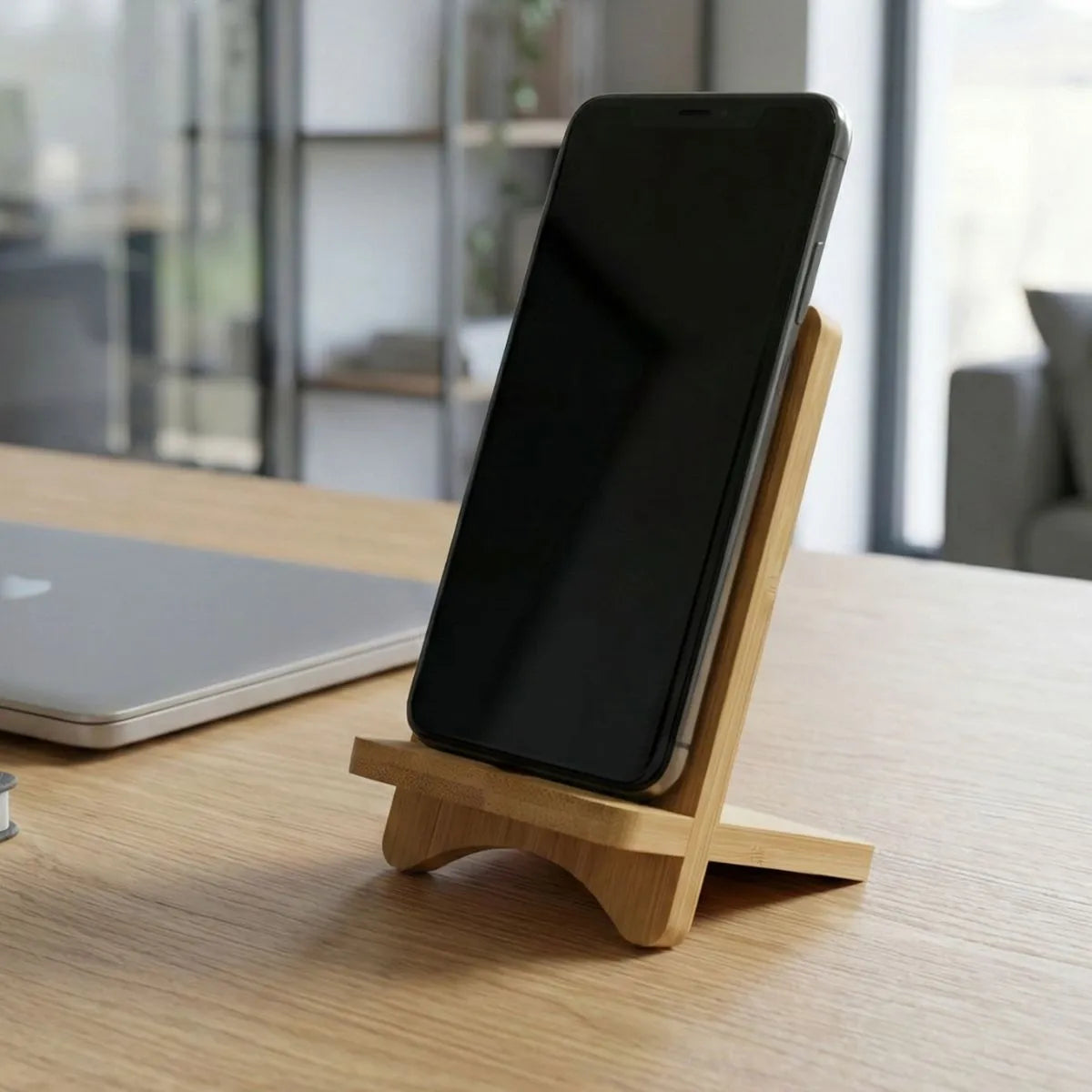Bamboo Mobile Phone Stand displaying a smartphone on a desk, perfect for work-from-home setups.