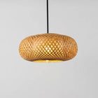Woven bamboo pendant lamp on a gray background