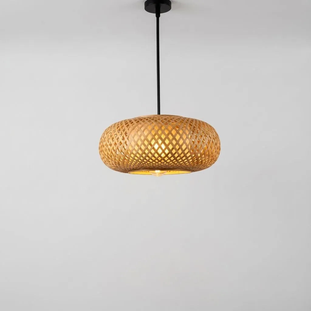 Woven bamboo pendant lamp on a gray background