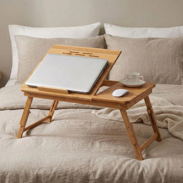 Bamboo Laptop Bed Table with laptop, cup, and mouse on a bed, perfect for working and relaxing.
