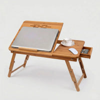 Bamboo Laptop Bed Table with a laptop, coffee cup, and mouse on a folding wooden table.