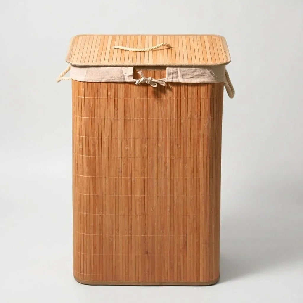 Bamboo laundry basket with a lid on a light gray background