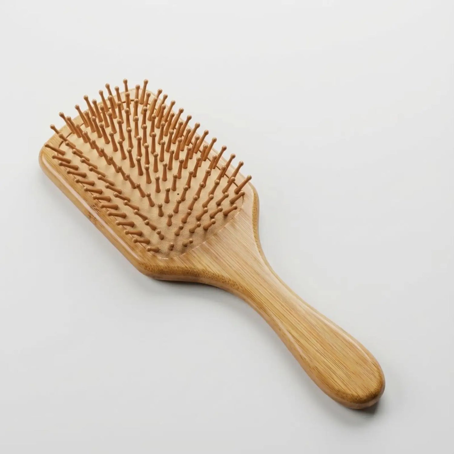 Bamboo hairbrush on a light gray background