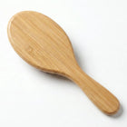 Bamboo Oval Hairbrush made from natural bamboo, featuring a smooth oval design perfect for detangling hair.
