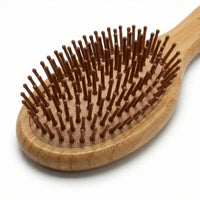 Bamboo Oval Hairbrush featuring smooth, rounded bristles for gentle detangling and soothing scalp massage.