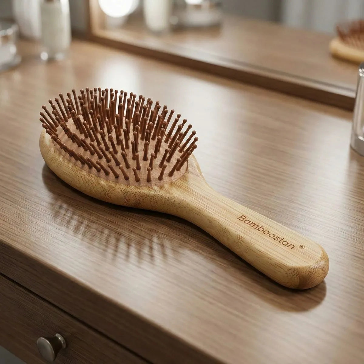 Bamboo Oval Hairbrush on a wooden table with a gentle design for smooth detangling and soothing scalp massage.