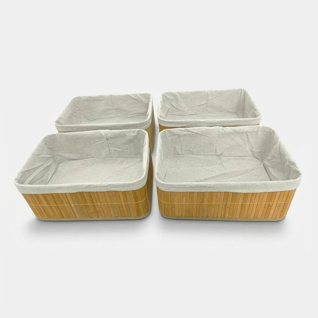 Set of four woven bamboo baskets with off-white liners on a white background