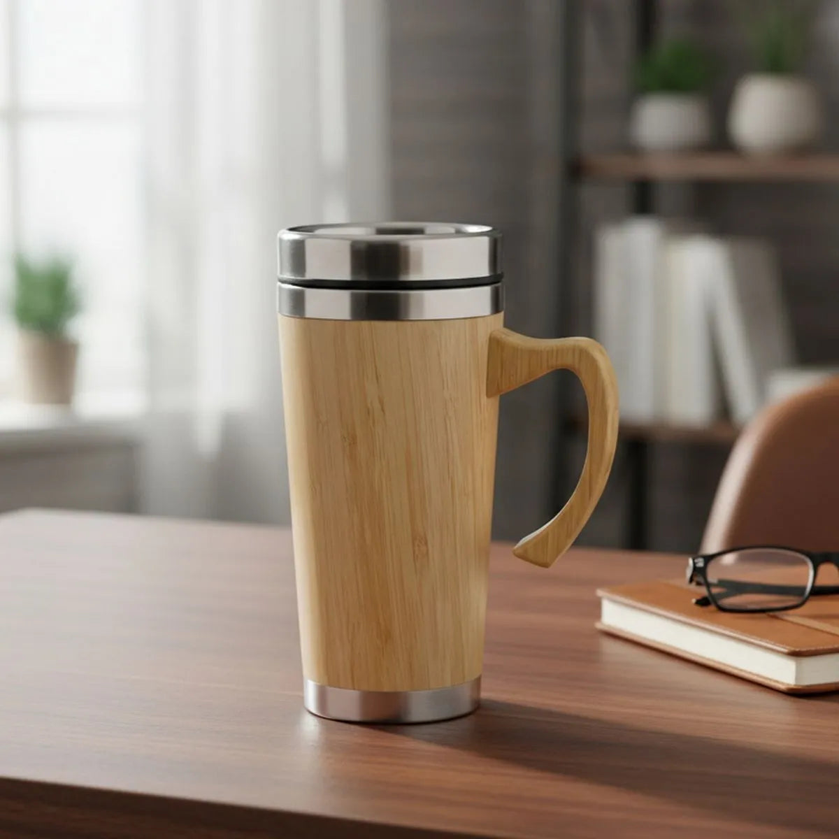 Bamboo Insulated Travel Mug with Handle on a desk, featuring a natural bamboo exterior and stainless-steel inner wall.