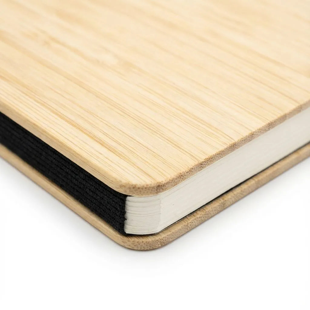 Close-up of a bamboo notebook with a white interior on a white background
