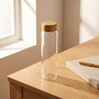Bamboo Glass Bottle on a minimal wooden desk with morning light