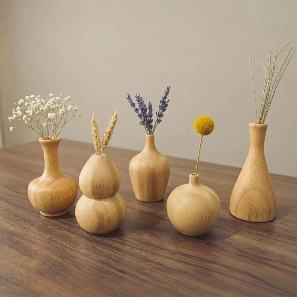Set of five Bamboo Mini Decor Vases showcasing natural beauty with dried flowers on a wooden table.
