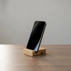 Mobile Tablet Stand holding a sleek smartphone on a wooden base, ideal for convenient viewing.