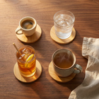 Natural Bamboo Round Coasters in use — each holding a different drink