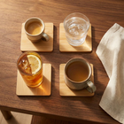 Natural Bamboo Square Coasters in use — each holding a different drink