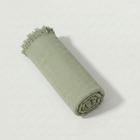 Bamboo Turkish Towel rolled in solid sage green, herringbone weave with matching fringe.