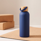 Water Bottle 500ml in matte navy blue on a cork yoga mat, bamboo cap with carry strap.